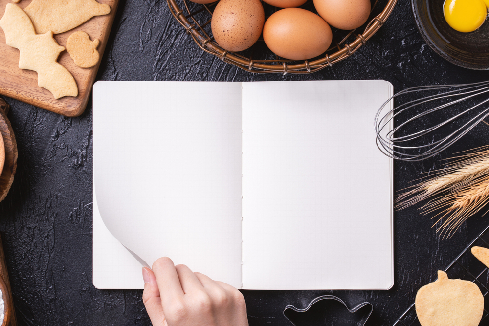 Woman,Is,Reading,Cookbook,Recipe,Of,Making,Halloween,Cookies,With